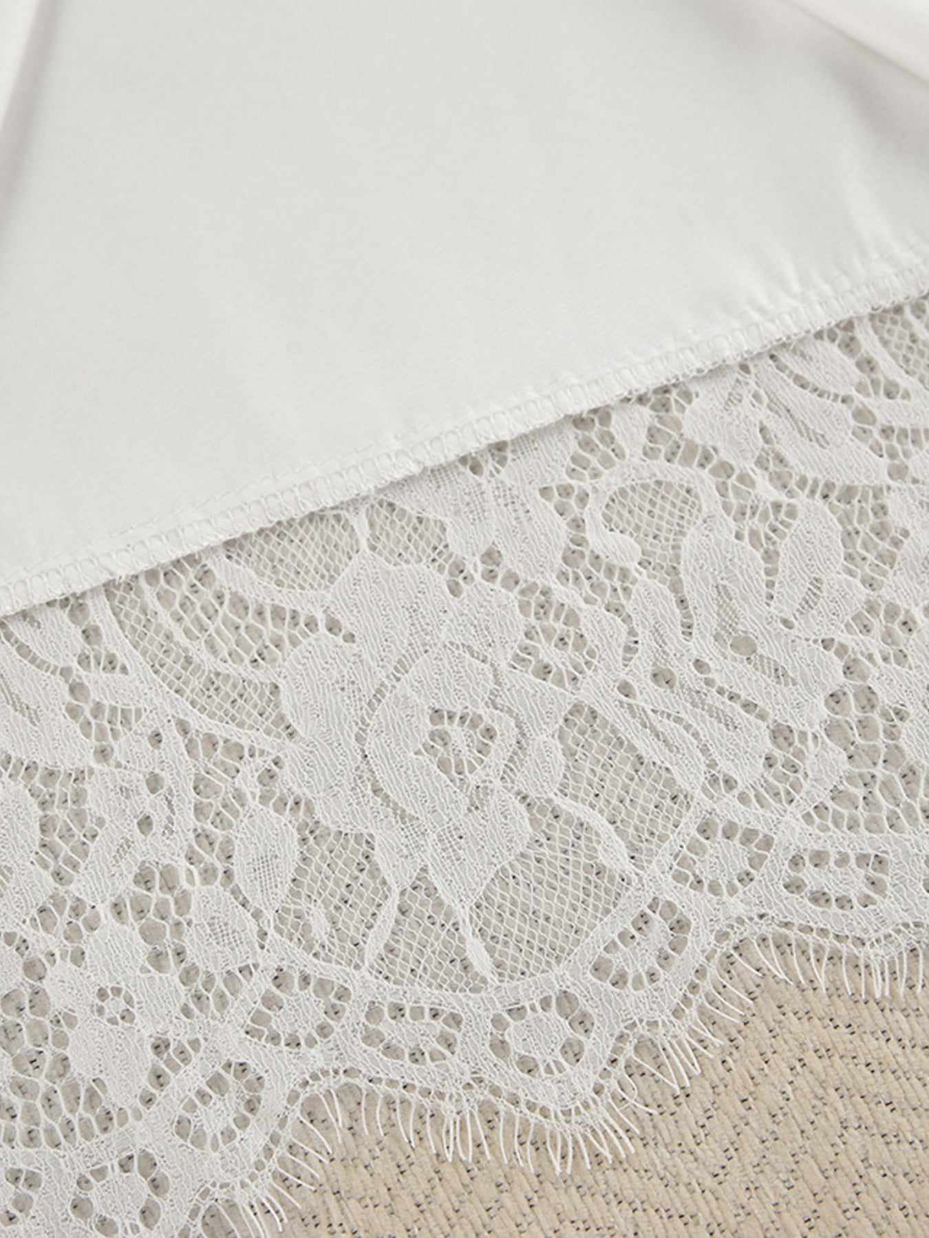 White lace trim detail on a soft fabric lounge set.