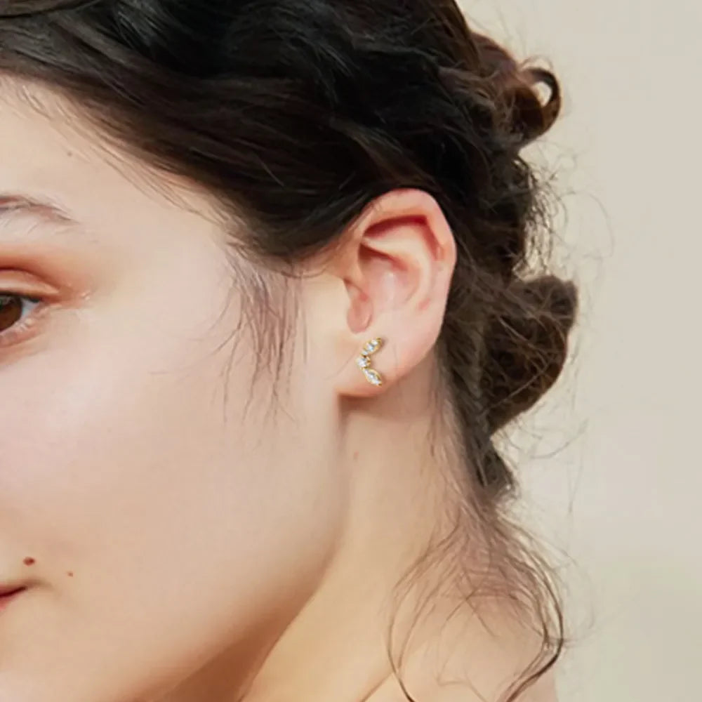 Gold moissanite leaf cluster stud earrings with cubic zirconia accents.