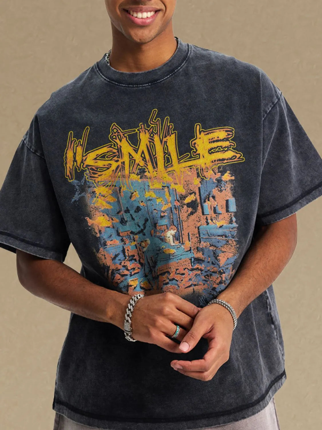Washed black oversized graphic tee with abstract yellow, blue, and orange print.