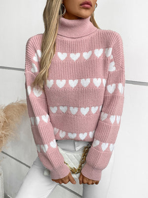 Blush pink acrylic turtleneck sweater with white intarsia hearts.