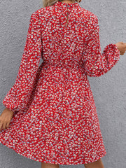 Crimson floral mini dress with gathered sleeves and high neckline.