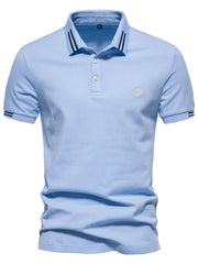 Light blue textured polo shirt with striped collar and sleeve detail