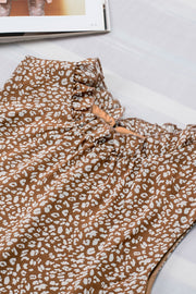 Brown printed sleeveless blouse with ruffled neckline detail