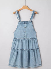 Tiered denim overall dress in light blue with button front and ruffled tiers.