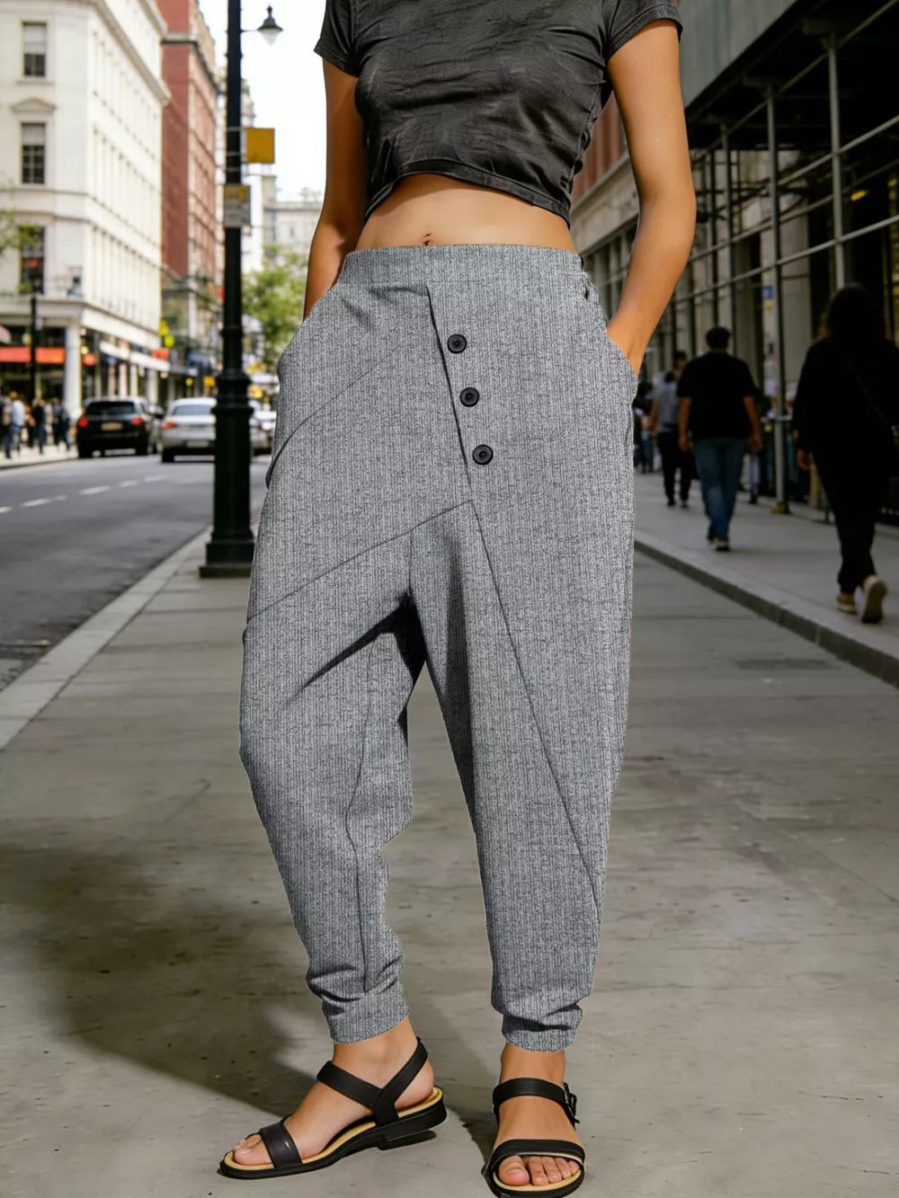 Gray harem pants with decorative buttons and pockets, cuffed ankles.