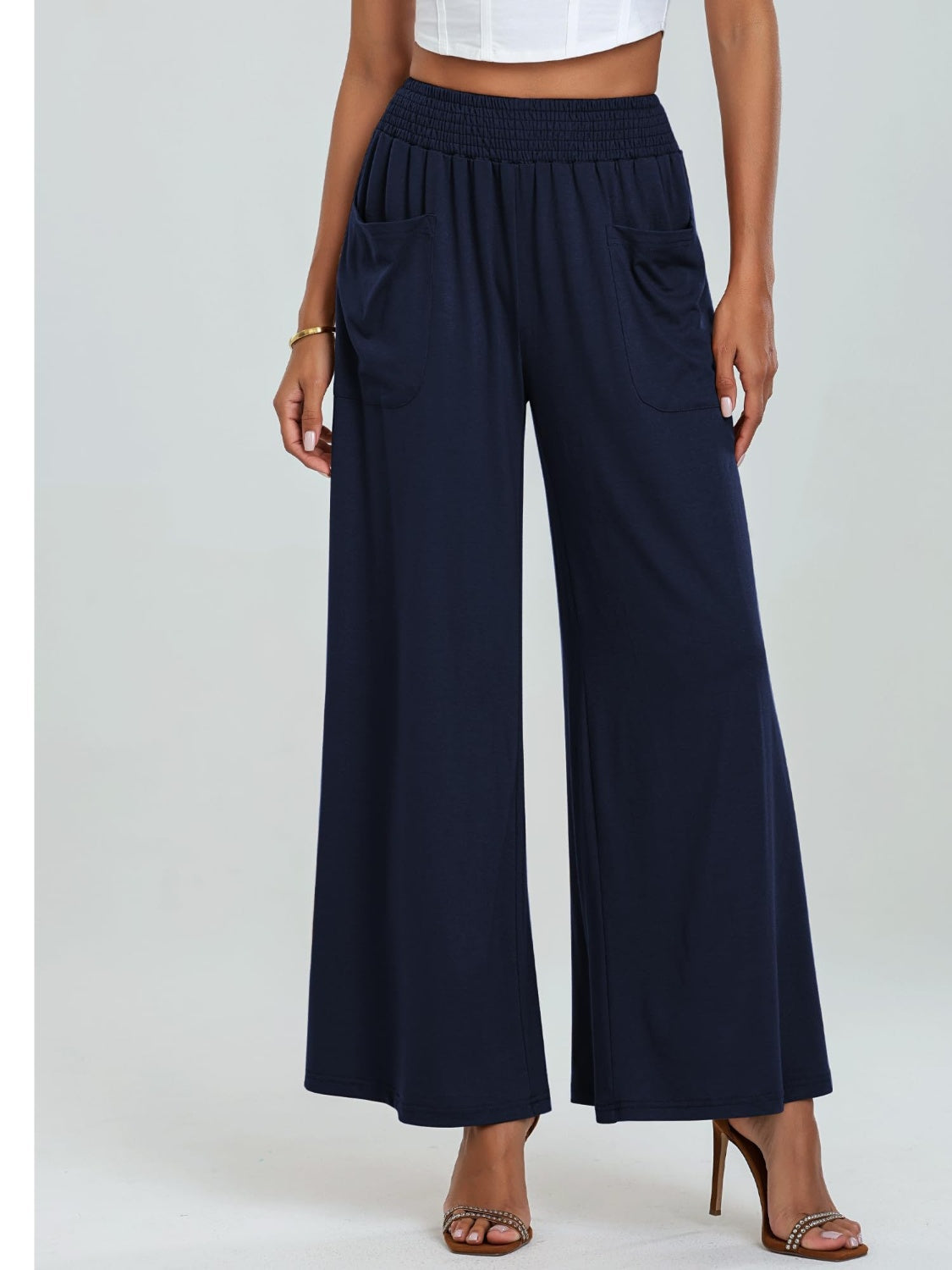 Navy elastic waist palazzo trousers with wide legs and front pockets.