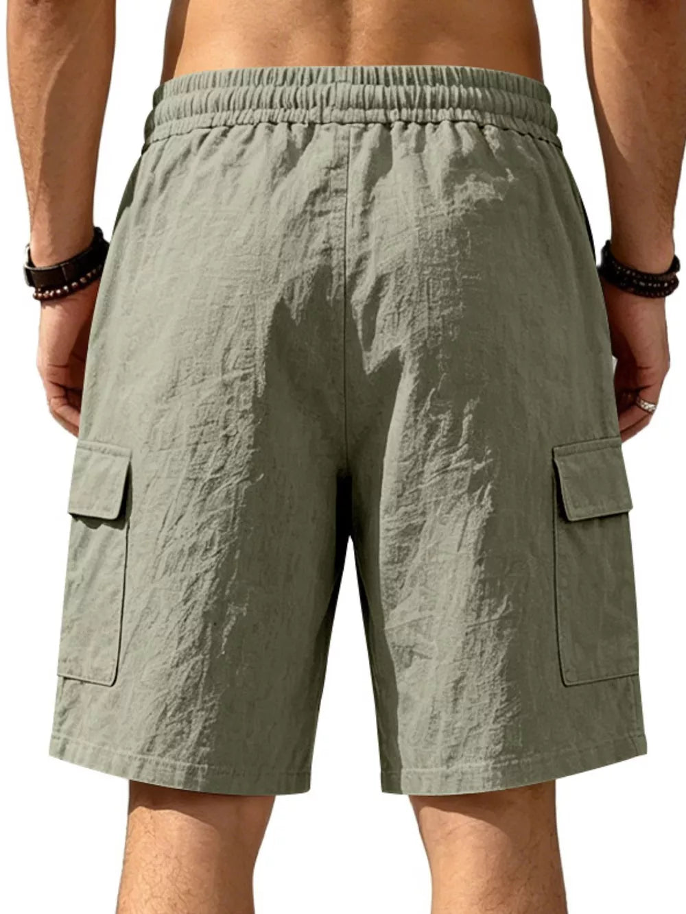 Military green cargo shorts with drawstring waist and crinkled texture.