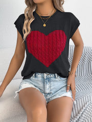 Black cable knit sweater vest with red cable knit heart graphic detail.