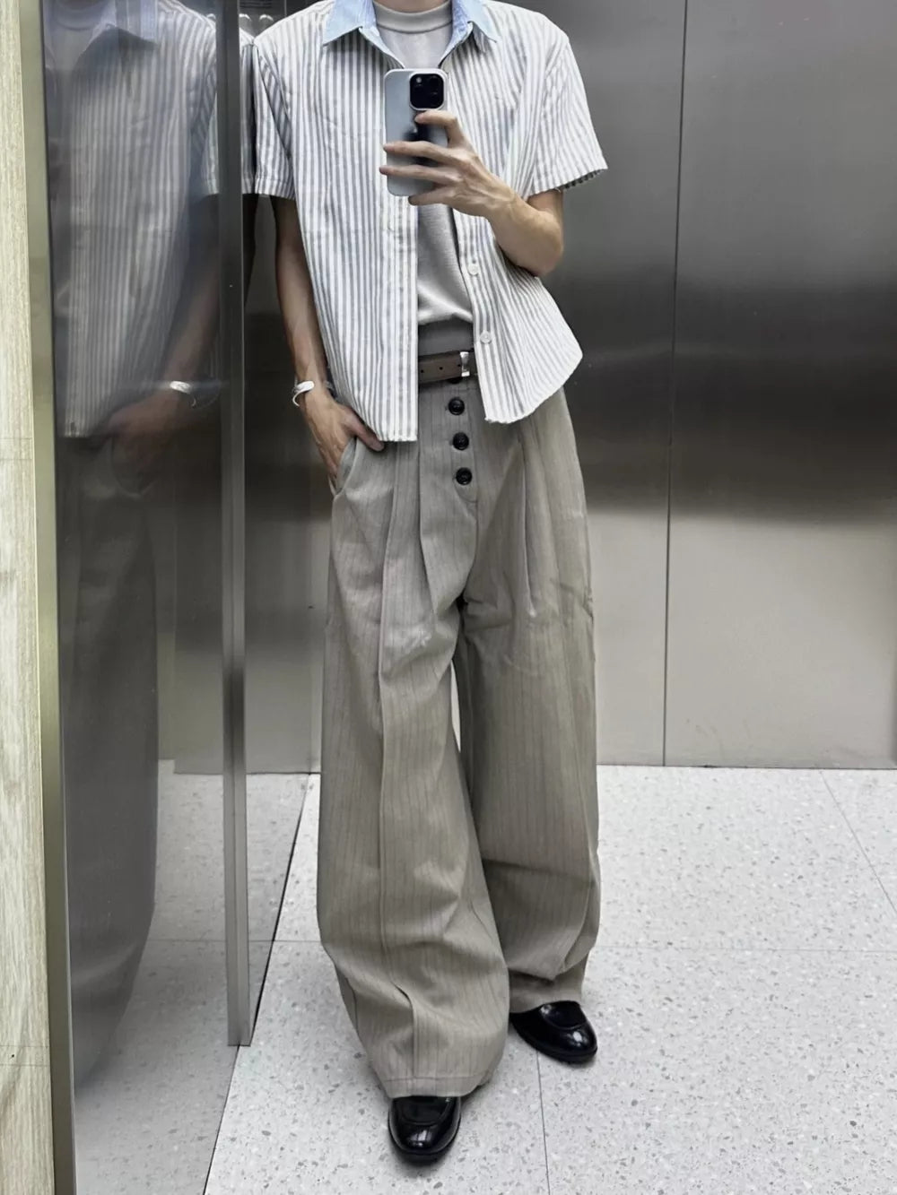 High-waisted wide-leg pants in khaki with pinstripes and button fly detail.