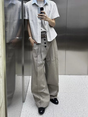 High-waisted wide-leg pants in khaki with pinstripes and button fly detail.