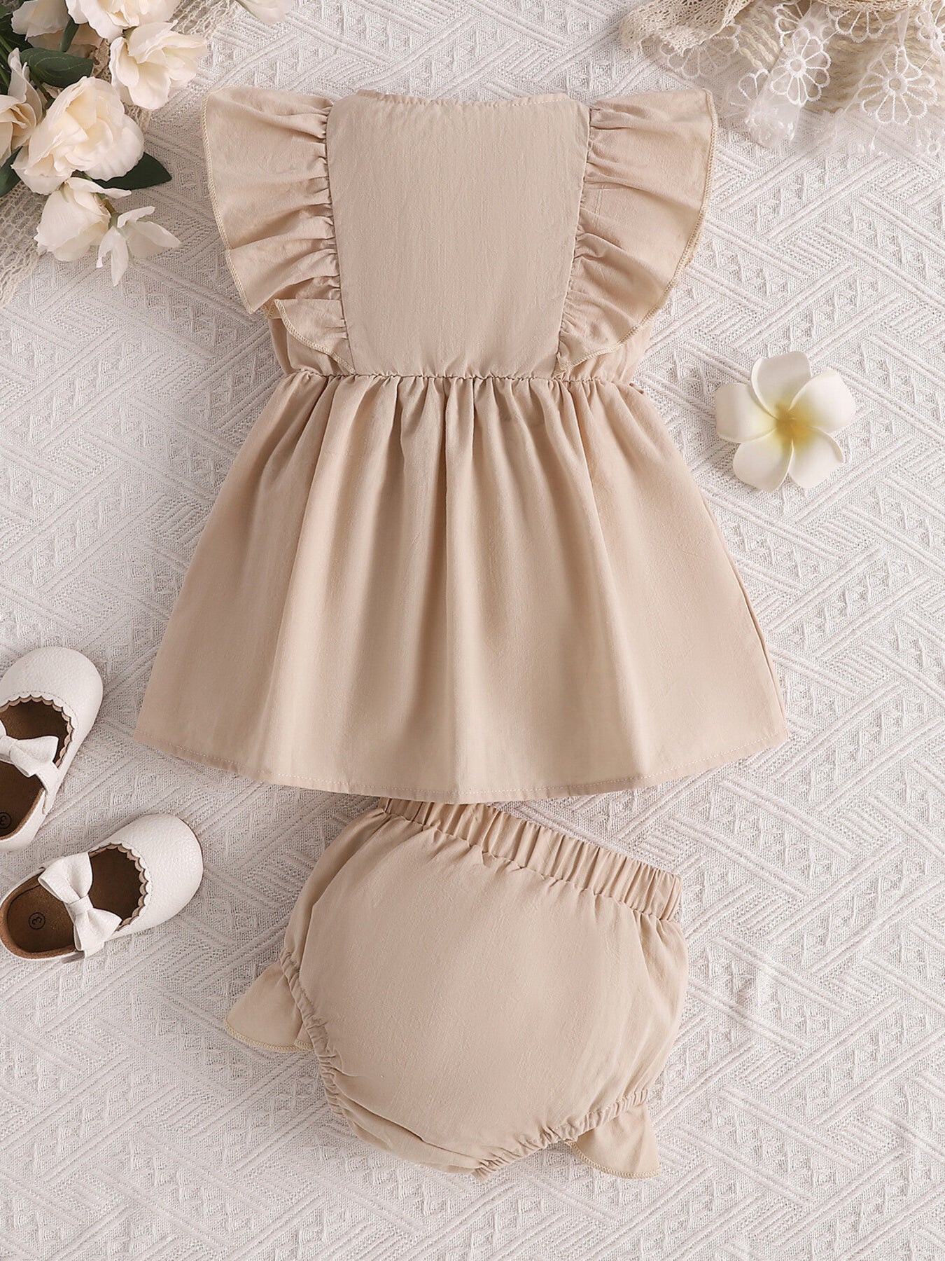 Apricot baby set with ruffled sleeves and bloomer bottoms.