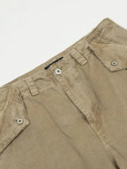 Khaki distressed utility wide-leg cargo pants with button flap pockets.