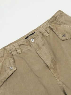 Khaki distressed utility wide-leg cargo pants with button flap pockets.