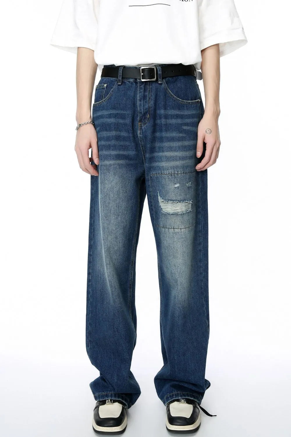 Baggy denim patchwork jeans in medium wash with distressed details and a relaxed fit.