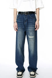 Baggy denim patchwork jeans in medium wash with distressed details and a relaxed fit.