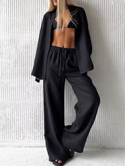Black relaxed fit two-piece set with button-up shirt and wide-leg drawstring pants.