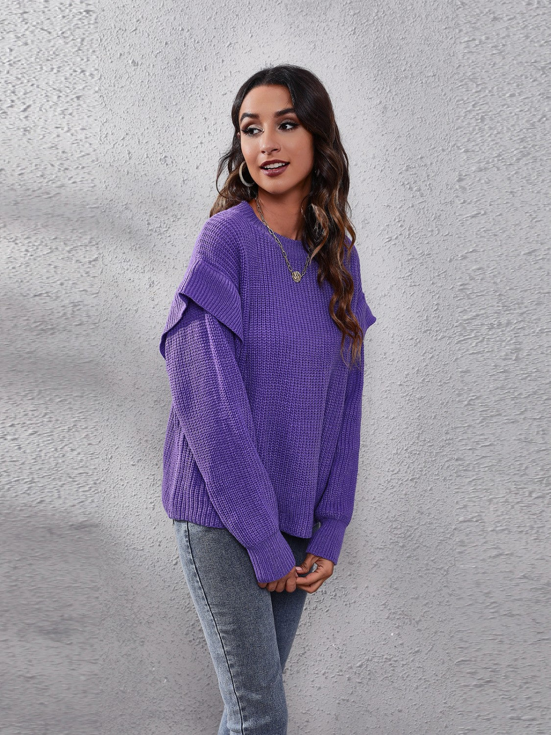 Purple ribbed knit pullover sweater with ruffled sleeves and crew neck.