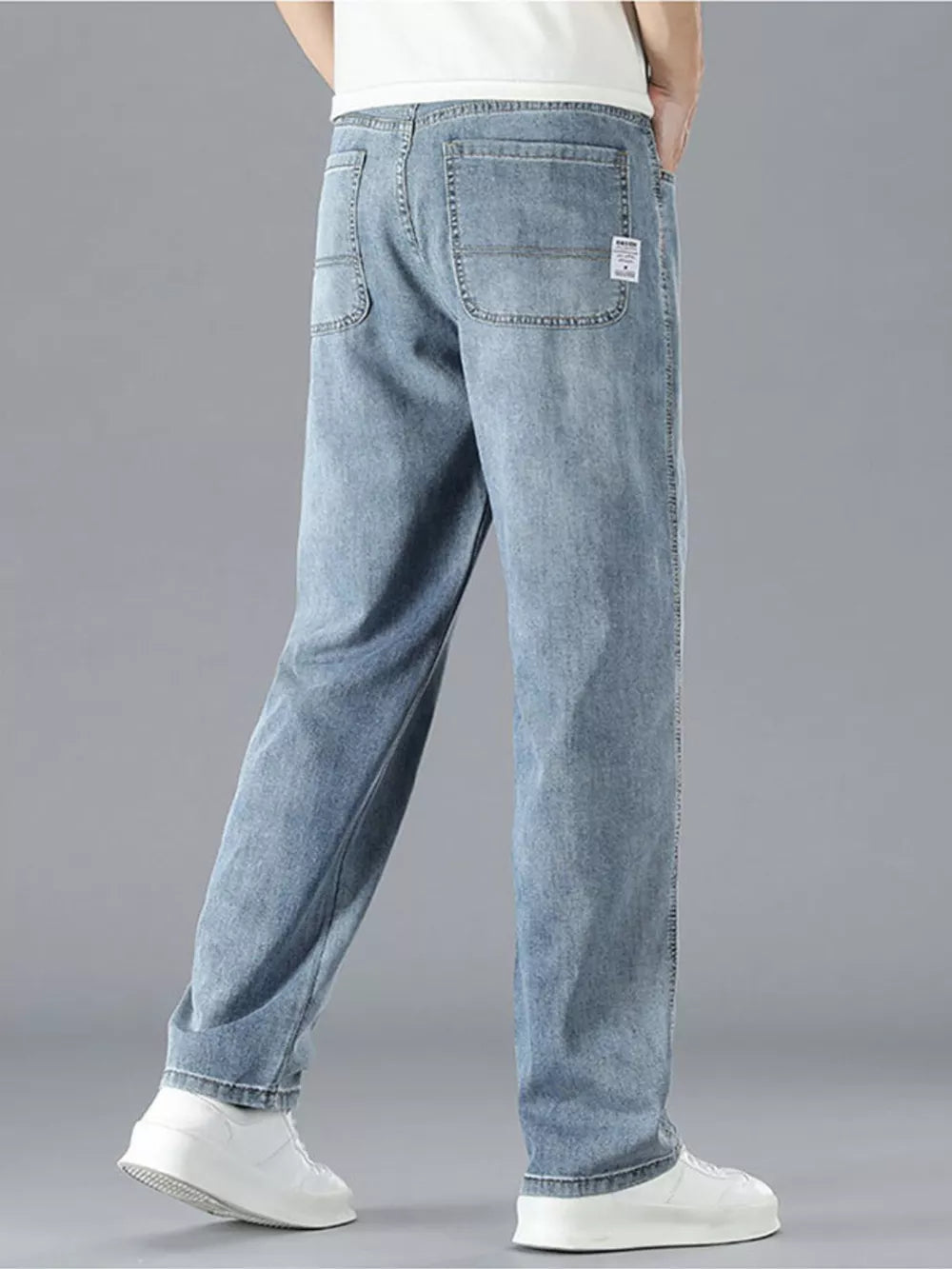 Men's light blue cotton straight leg jeans with classic five-pocket styling.