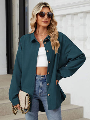 Oversized corduroy shirt jacket in dark navy with button front and collar.