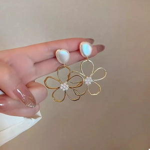 Gold floral drop earrings with pearl and crystal accents.