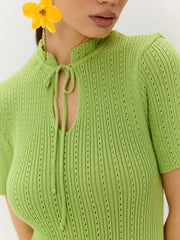 Lime green knitted mermaid dress with tied neckline and eyelet details.