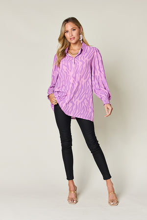 Lavender zebra print blouse with shirred cuffs and puff sleeves.