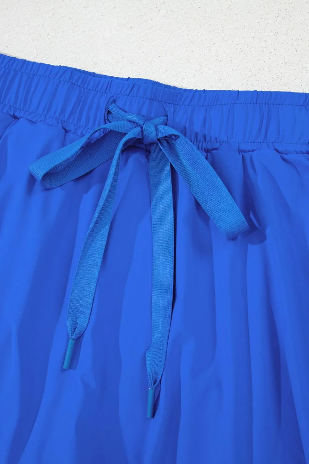 Blue flared skort with elastic waist and tie detail
