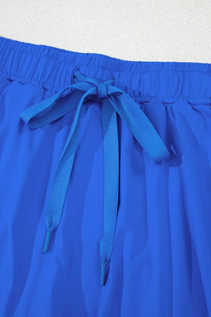Blue flared skort with elastic waist and tie detail