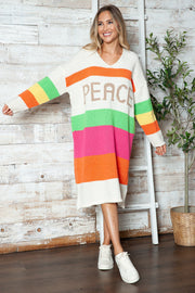Beige knit midi sweater dress with rainbow stripes and PEACE lettering.