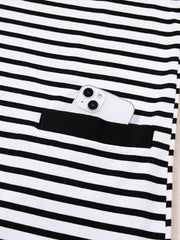 Black and white striped collared dress with button detail and functional pocket holding a phone.