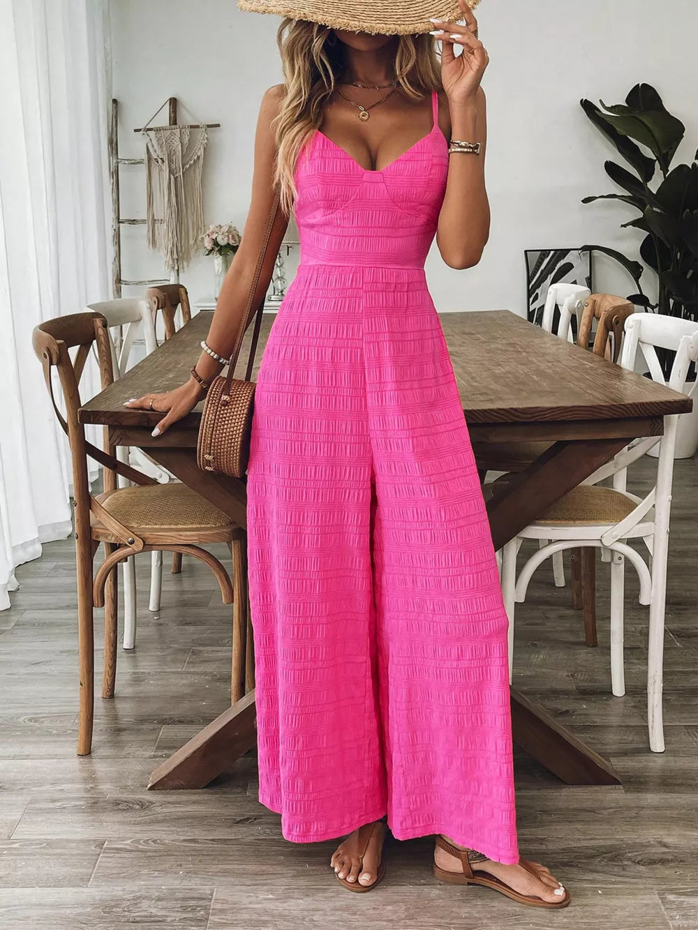 Rose Red maternity romper with wide legs and textured fabric, featuring a V-neck and spaghetti straps.