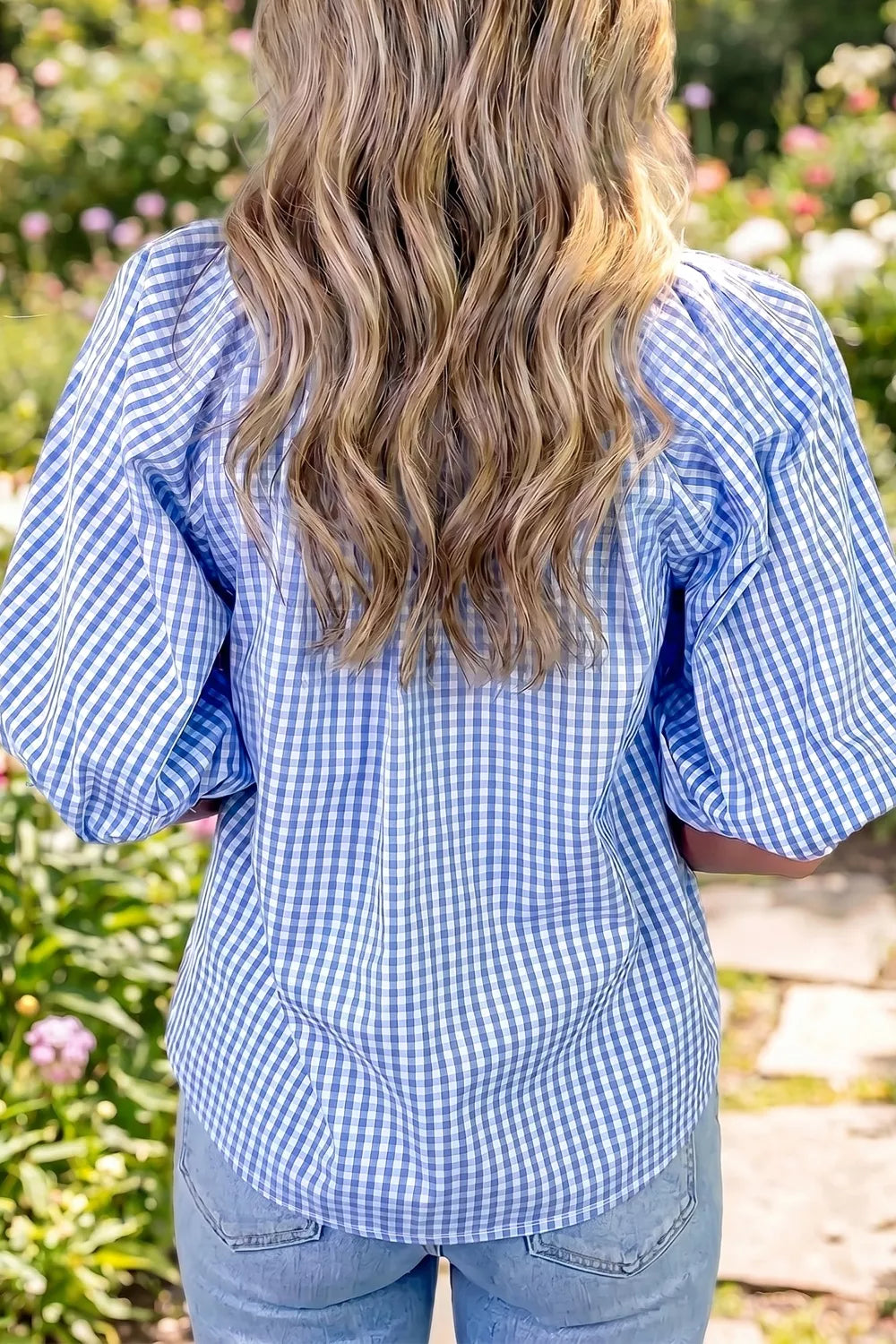 Blue gingham cotton blend shirt with puff sleeves and gathered V-neck detail.