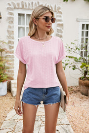 Perforated sleeve tee in blush pink with rolled cuffs and a round neckline.