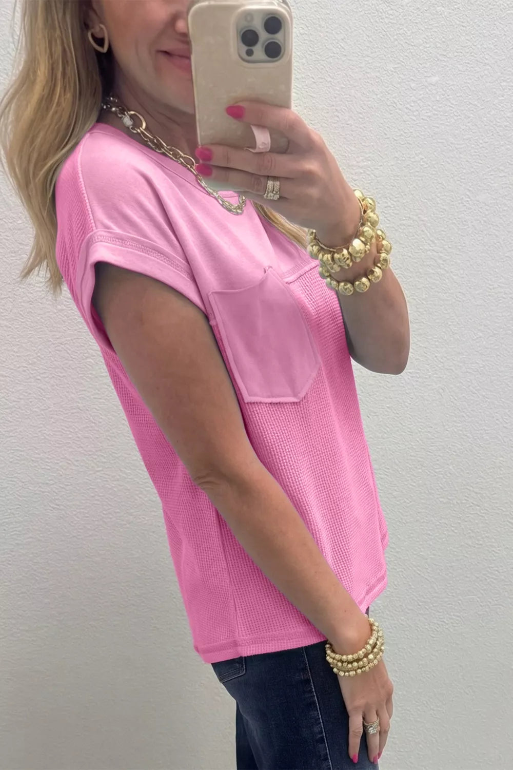 Pink waffled seam pocketed t-shirt with short sleeves and a crew neck.