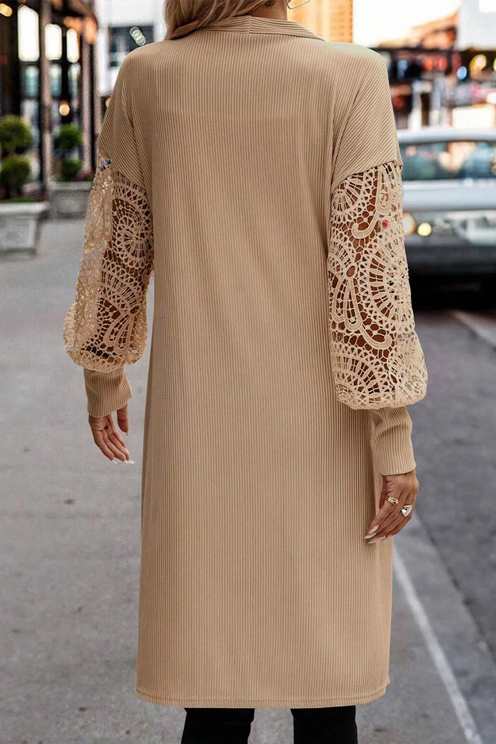 Tan ribbed knit duster cardigan with intricate lace balloon sleeves.