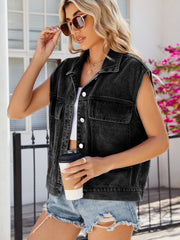 Black denim utility vest with button front and chest pockets, worn by a woman.