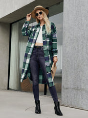 Oversized plaid shirt jacket dress in green and navy with button front and pockets.