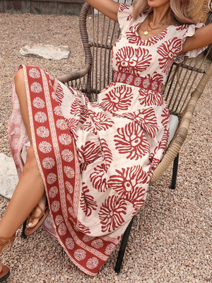 Floral V-neck maxi dress with ruffled sleeves, smocked waist, and border print hem.