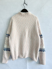 Geometric knit mockneck pullover in Eggshell with blue and pink flecks and geometric sleeve detail.