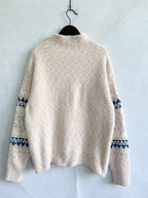 Geometric knit mockneck pullover in Eggshell with blue and pink flecks and geometric sleeve detail.