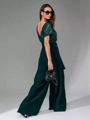 Dark green sequin wide-leg jumpsuit with tie waist and V-neck.