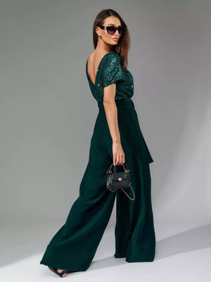 Dark green sequin wide-leg jumpsuit with tie waist and V-neck.