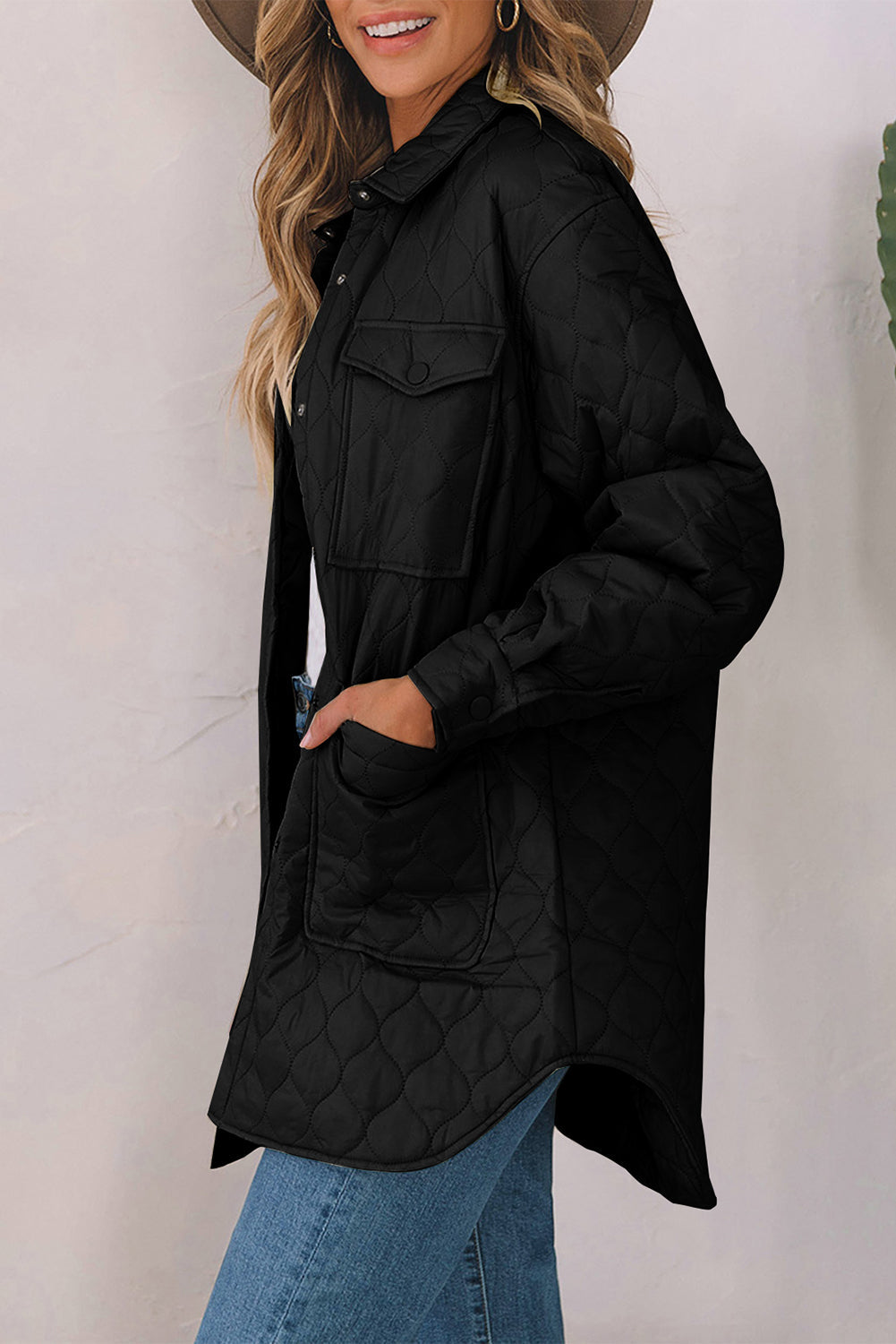 Black quilted utility jacket with button-flap chest pockets and side pockets.