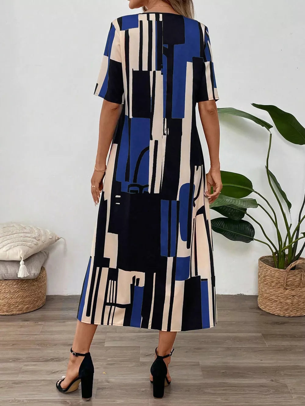 Midi dress with geometric print in blue, black, and cream, V-neck, short sleeves.