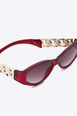 Deep Red cat-eye sunglasses with gold chain detail on temples.