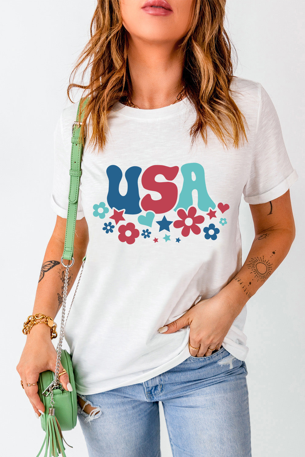 White graphic t-shirt with groovy USA text and floral pattern, crew neck, short sleeves.