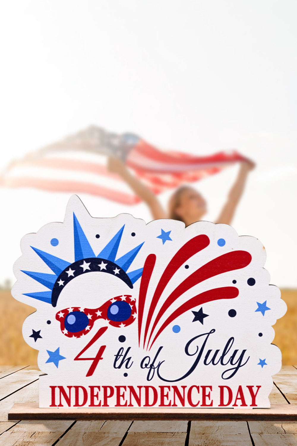 Patriotic Americana wooden tabletop decor with fireworks, stars, and 4th of July Independence Day text.