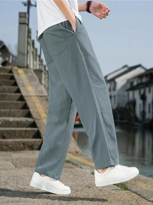 Men's light gray drawstring sweatpants with pockets, relaxed fit.