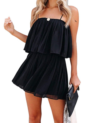 Black tiered cami romper with delicate straps and pleated skirt detail.