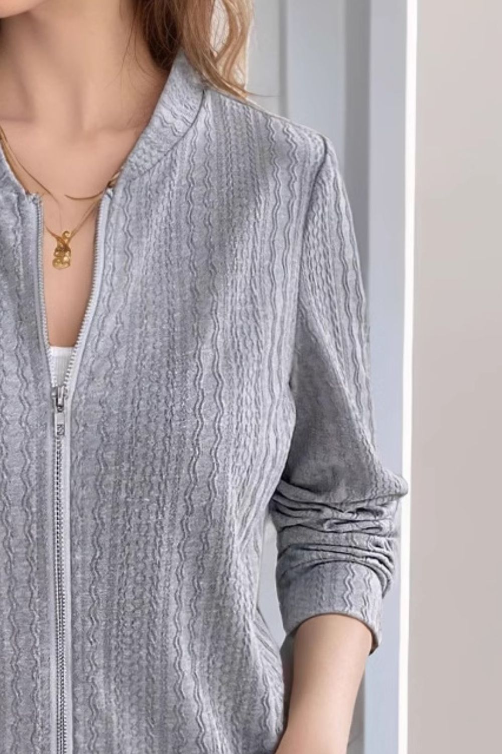Gray textured ribbed bomber jacket with a zip front and crew neck.